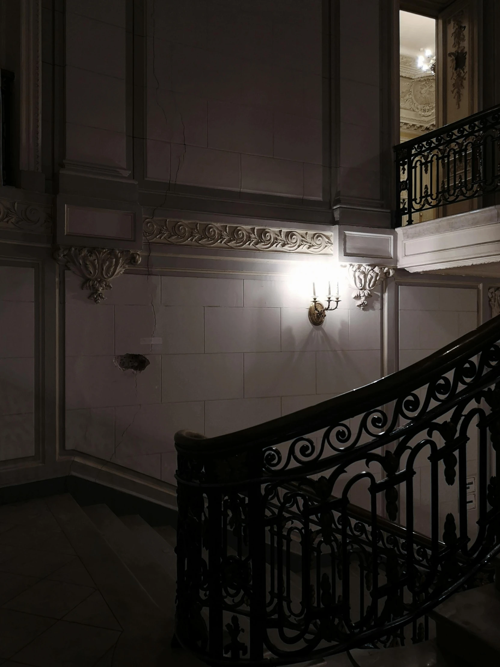 a dark staircase is in an old building