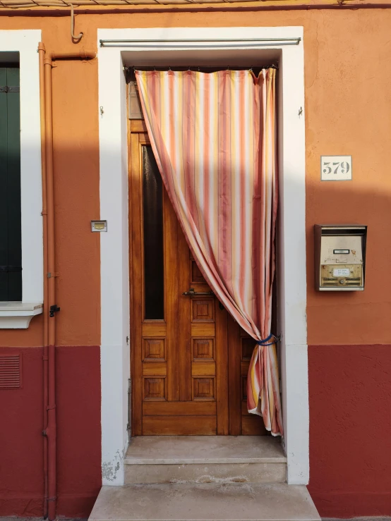 a door with a curtain closed and some signs