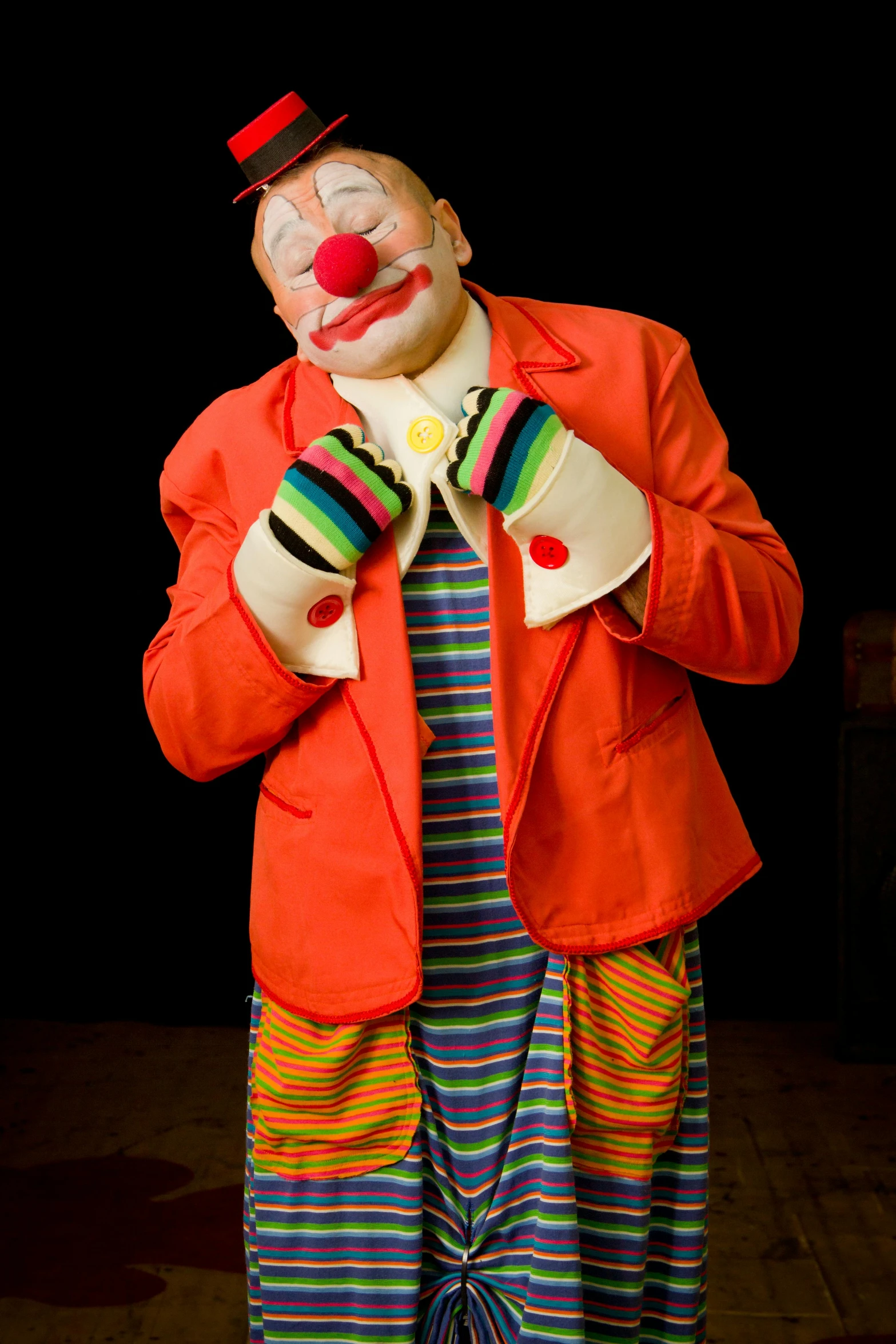 clown costume that is made of orange canvas and colorful clothes