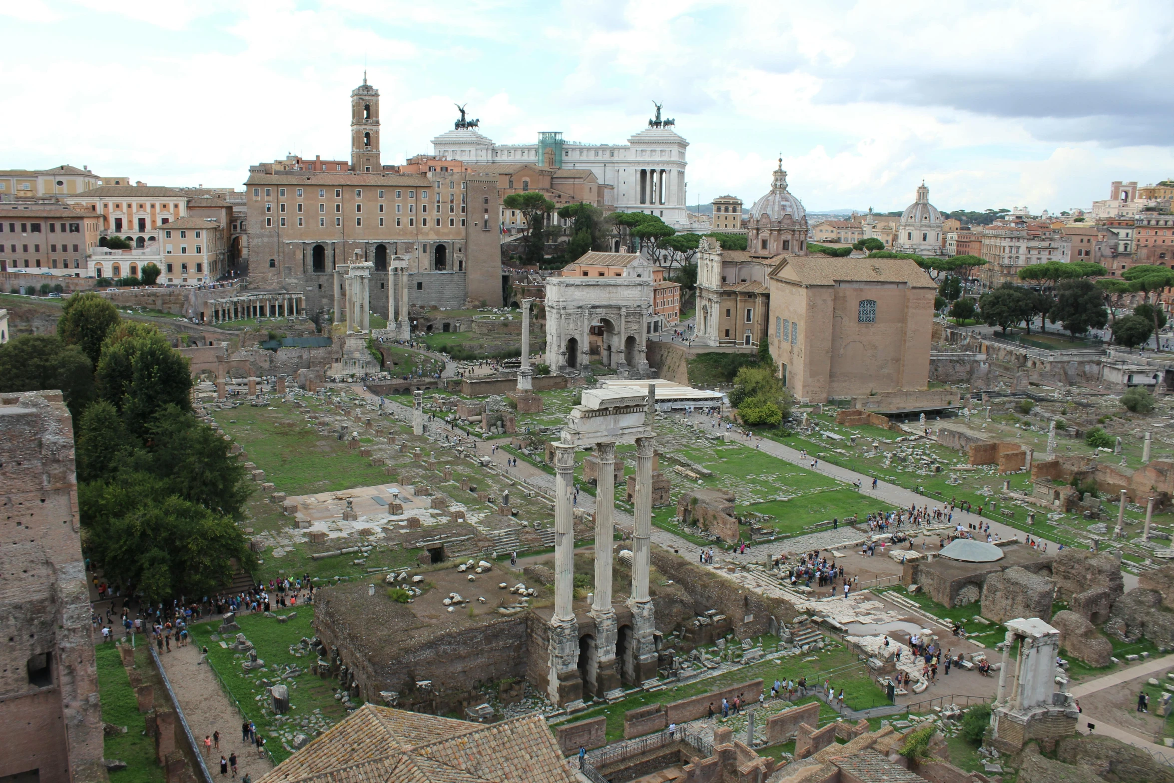 ruins of roman buildings and a cemetery in the distance