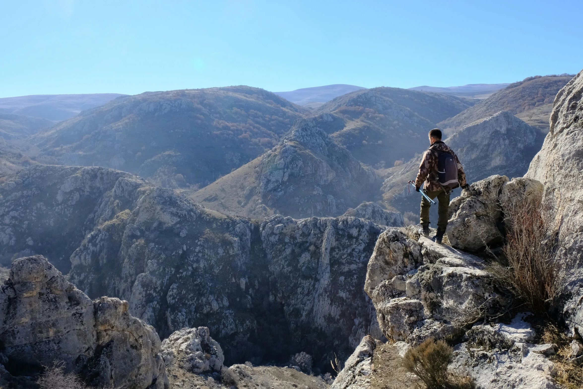 a person is standing on a rocky cliff