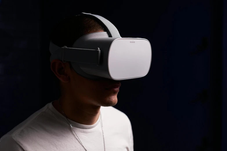 man wearing an oculus headpiece to display the device