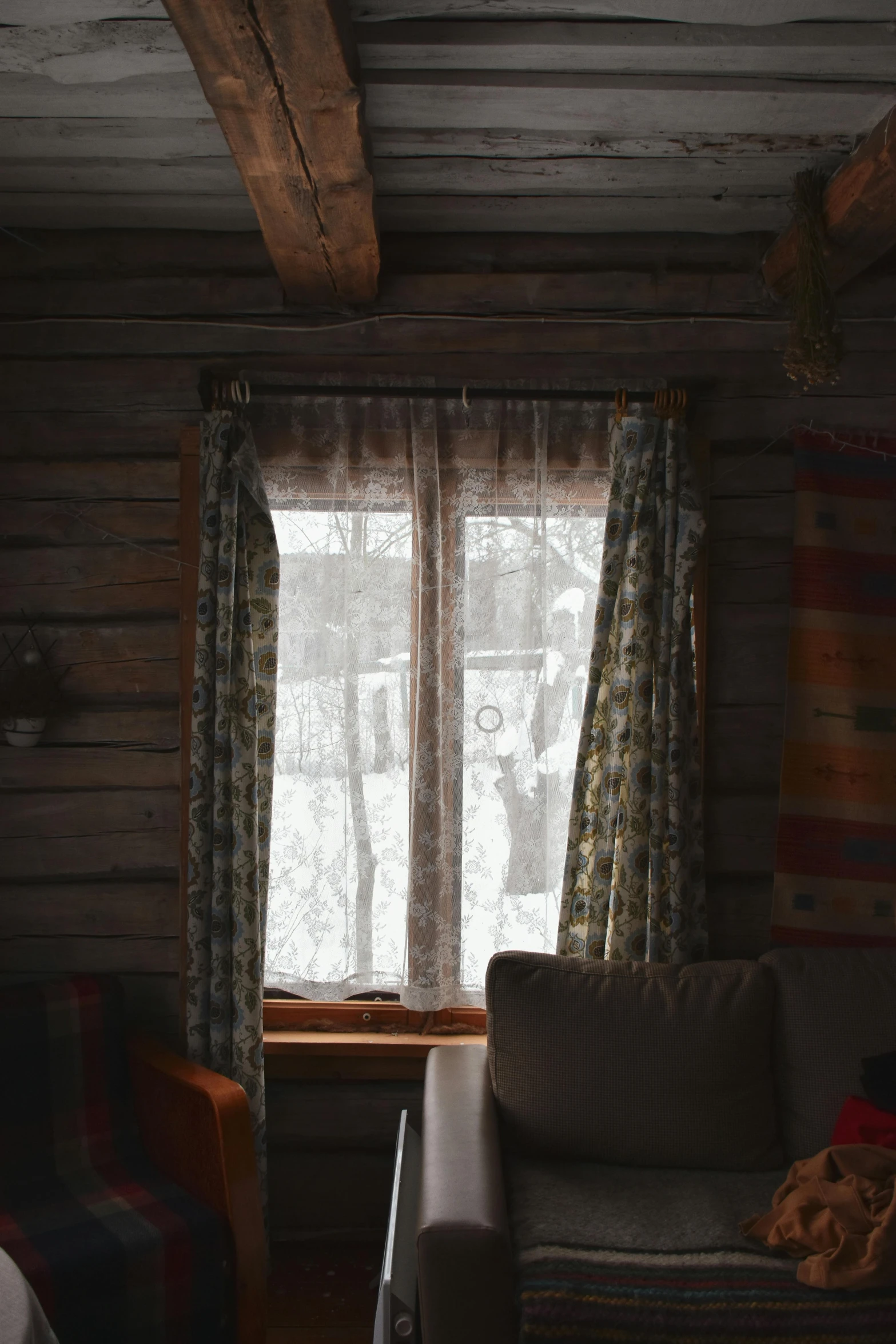 a large cabin with a sofa and chair sitting in front of a window