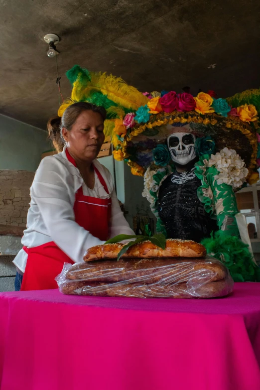 there is a woman that has bread on her table