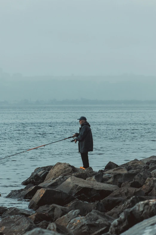 a man fishing while holding his boat's pole