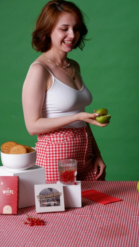 an image of a woman holding apples near other objects