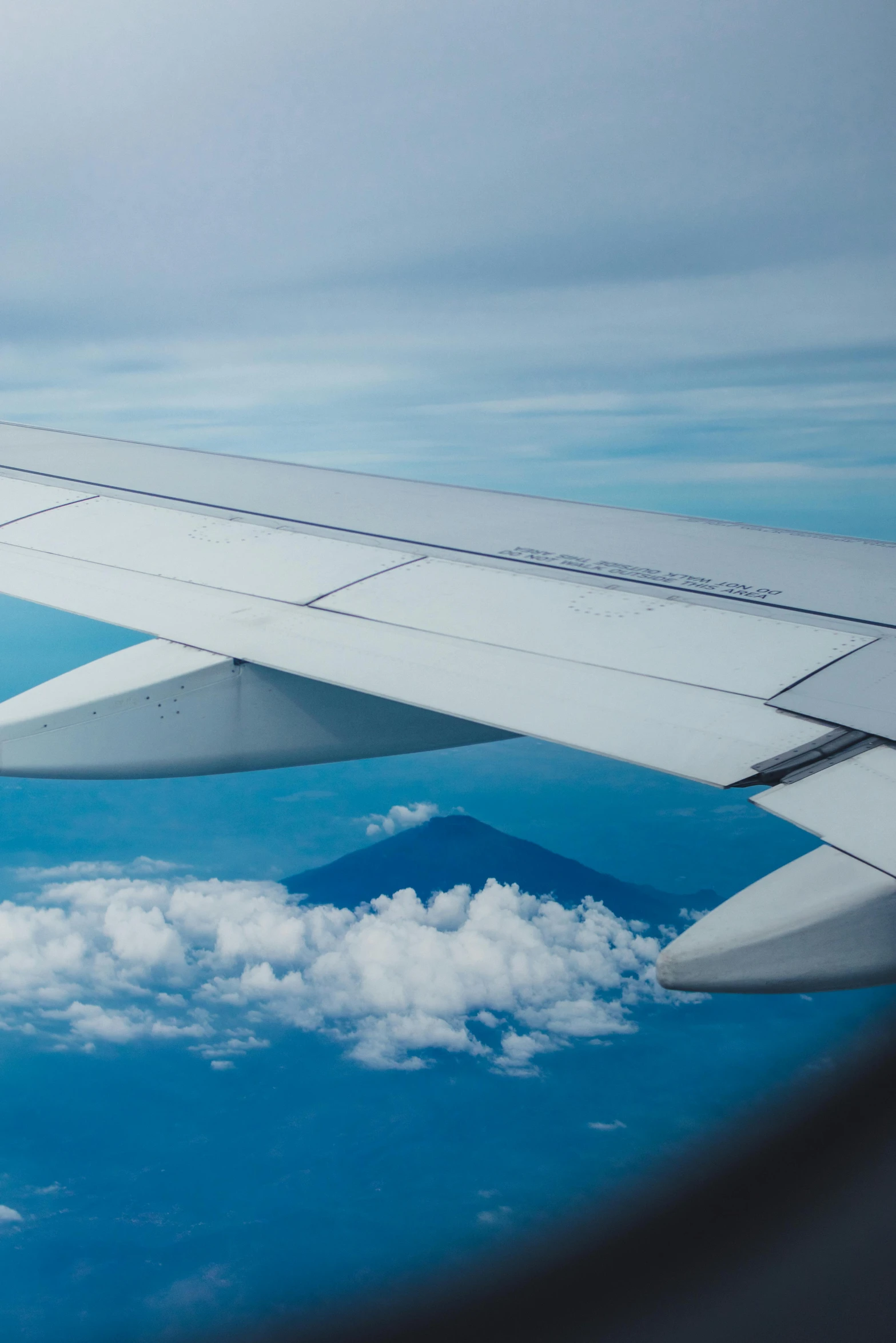 the wing of a plane flying high up in the air