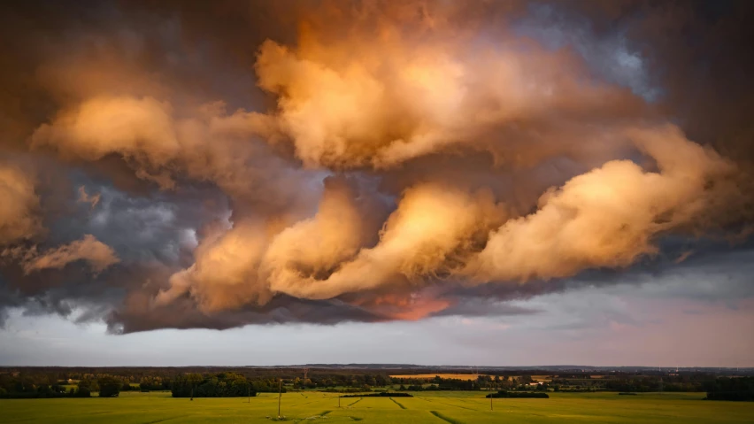 the sky is covered in clouds at sunset