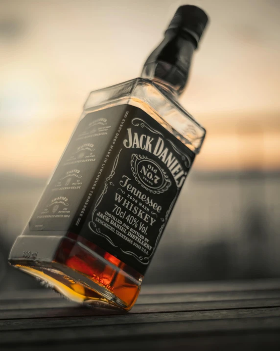 a bottle of jack daniels whiskey sitting on top of a table