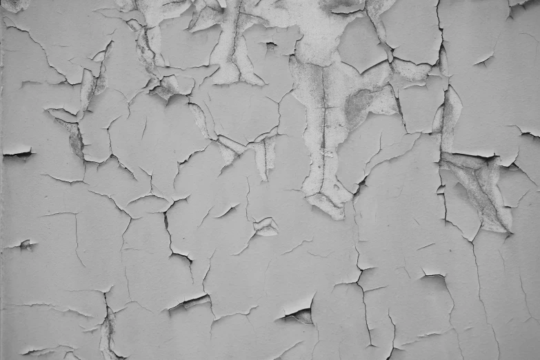white chipped paint on a gray wall
