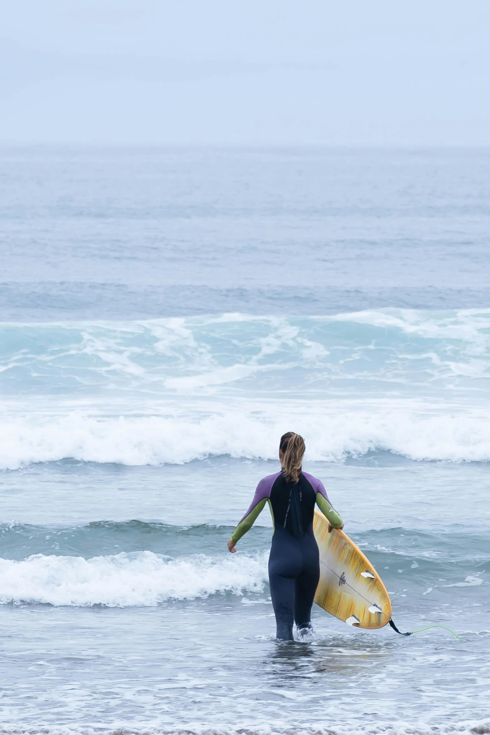 a person with a surf board on a beach