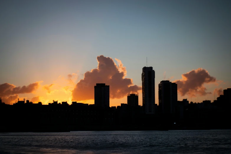 a city as the sun rises behind some buildings