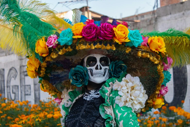 a skull wearing a large hat and holding flowers