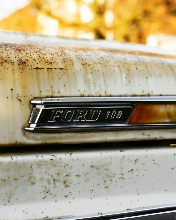 a rusted out car is shown from the hood up