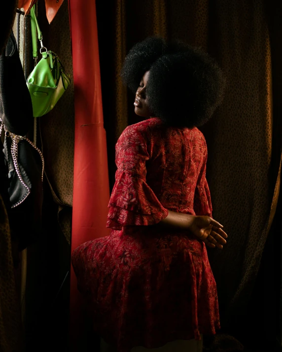 two dark haired woman in matching clothing with a red dress