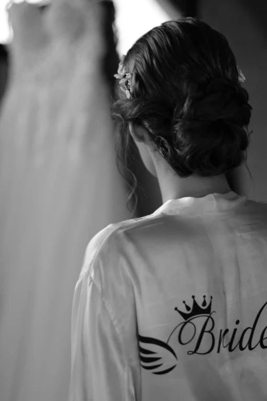 a woman in white jacket looking into the mirror