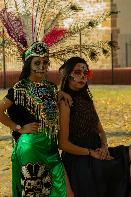 a couple of women wearing feathers standing next to each other