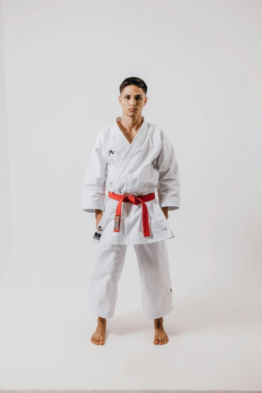 the man is posing with his karate outfit