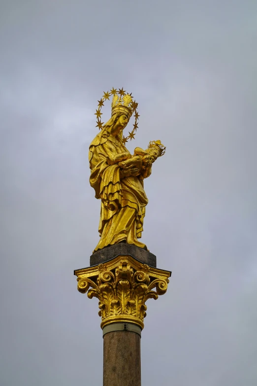 the statue is holding a crown of gold