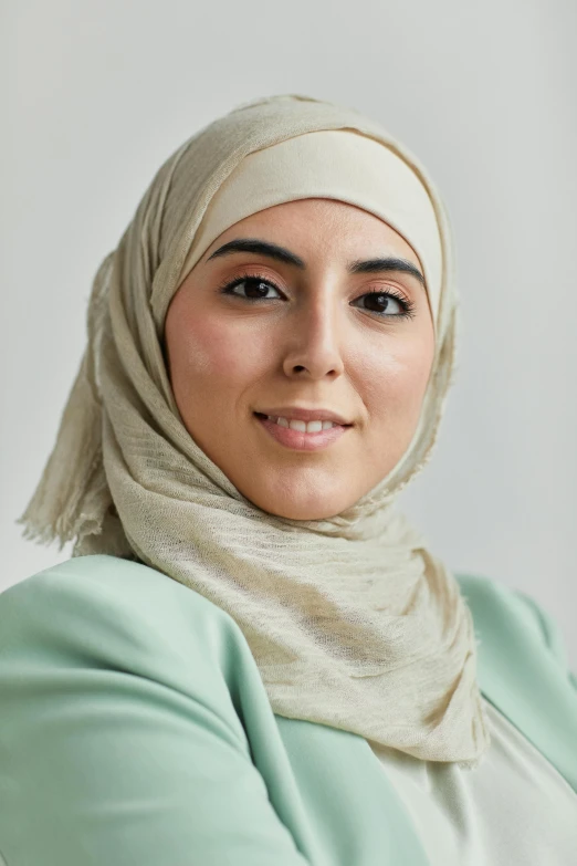 a beautiful woman with a headscarf smiling at the camera
