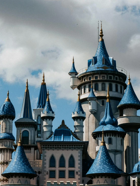 a castle is adorned in blue and gold domes