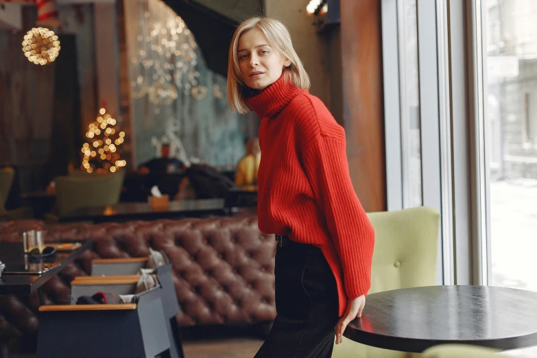 the woman stands near a table in the room