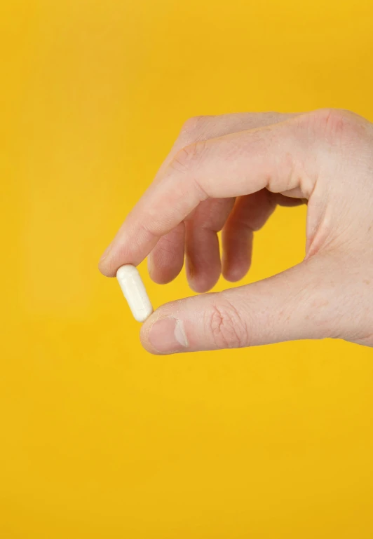 a hand holding an unopened cigarette and its end