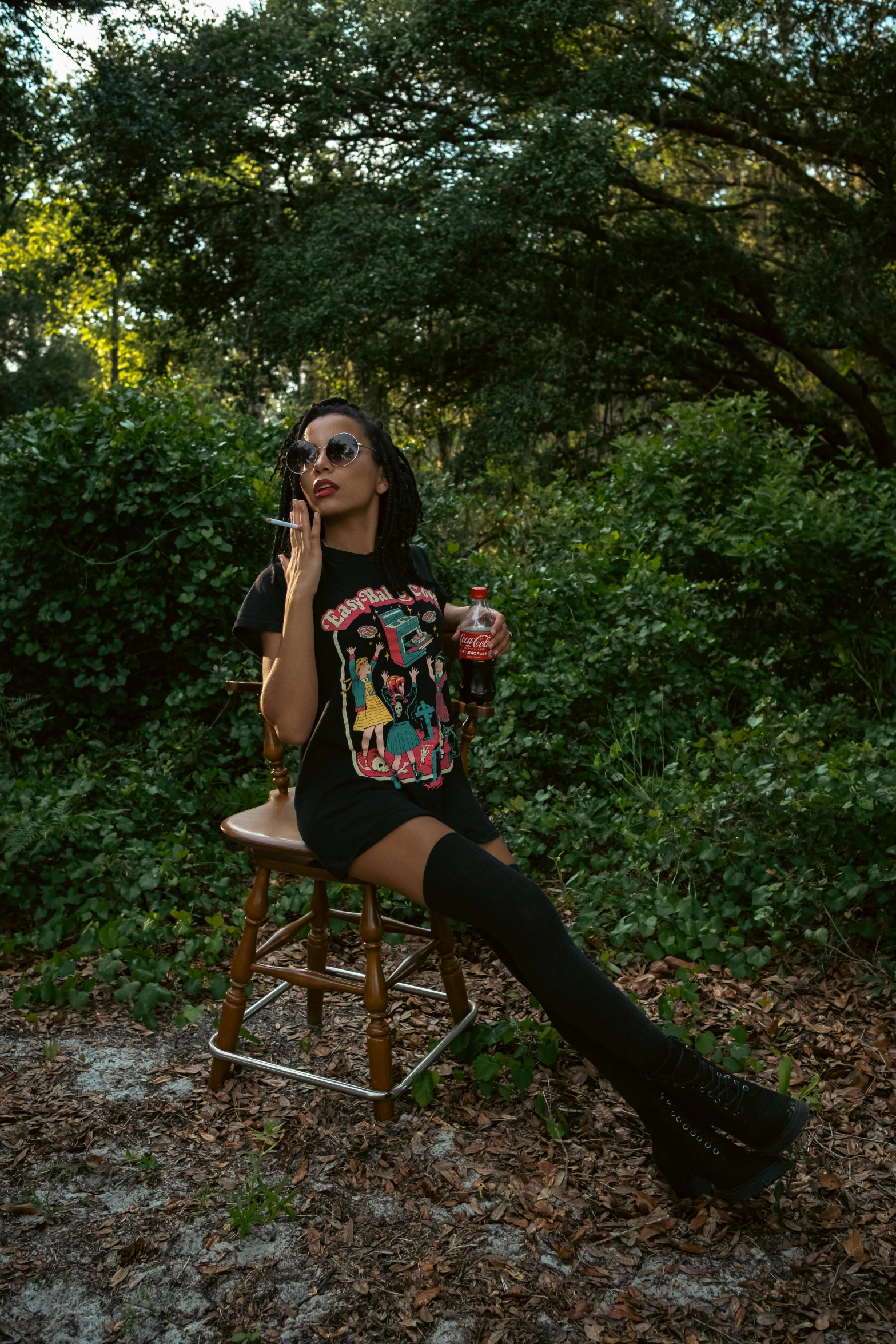 a woman smoking a cigarette while sitting on a bench in the middle of an area