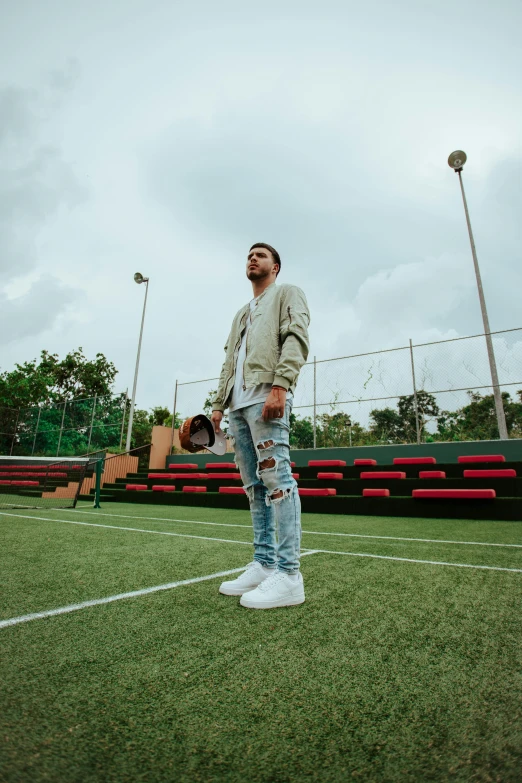 a man stands on the sidelines of a soccer field