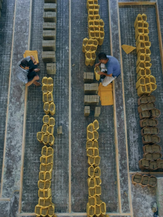 workers make gold letters in a factory floor