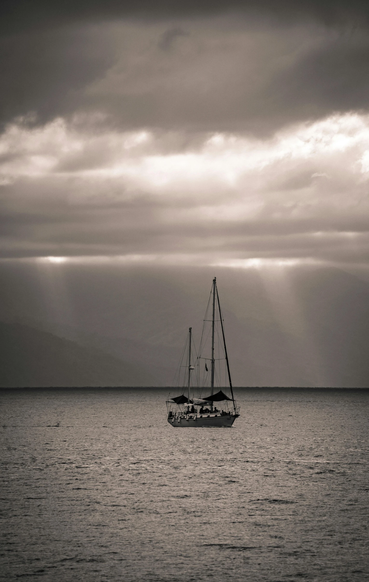 a boat on the water near some clouds