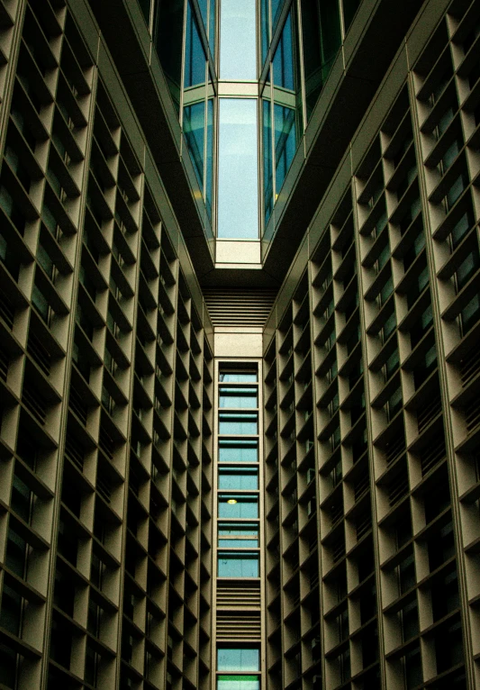 a tall, grey building with multiple windows in the middle