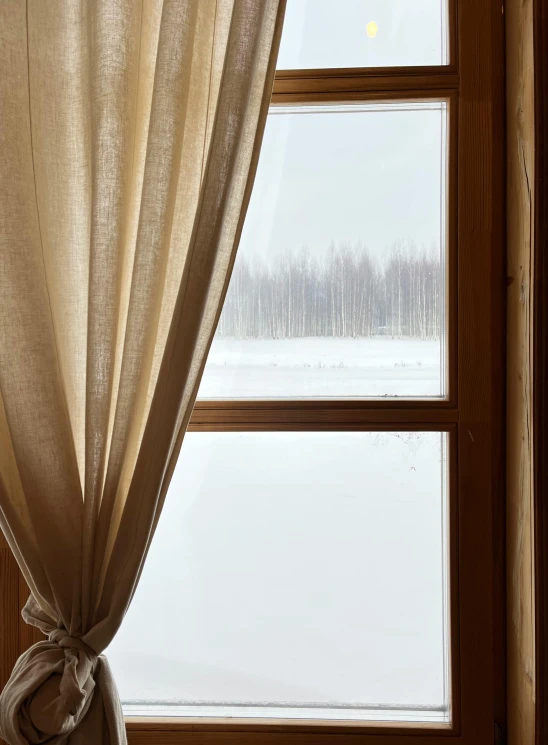 a curtain next to a window in a room