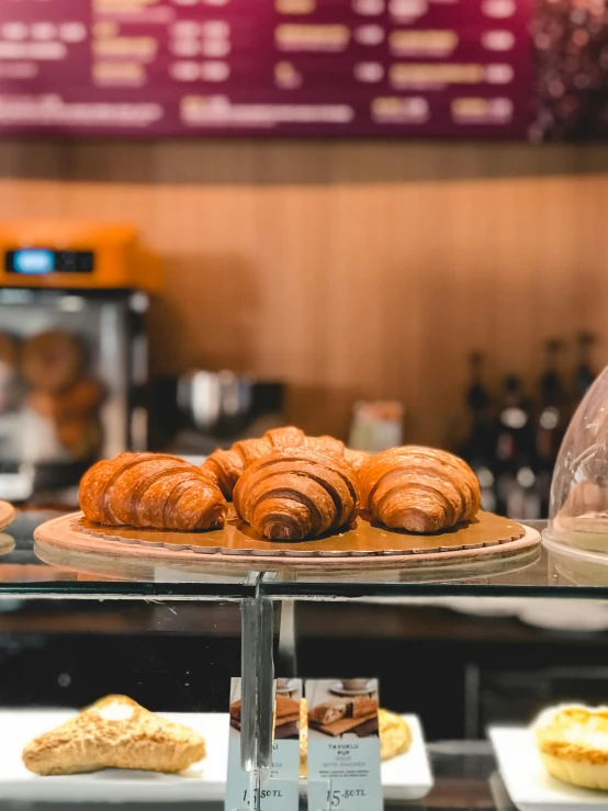 pastries are lined up for display on glass