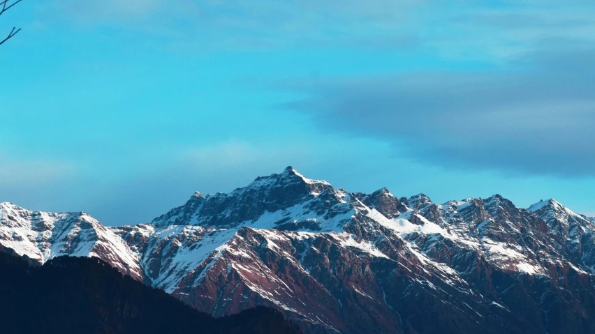 a large mountain covered in snow on a sunny day