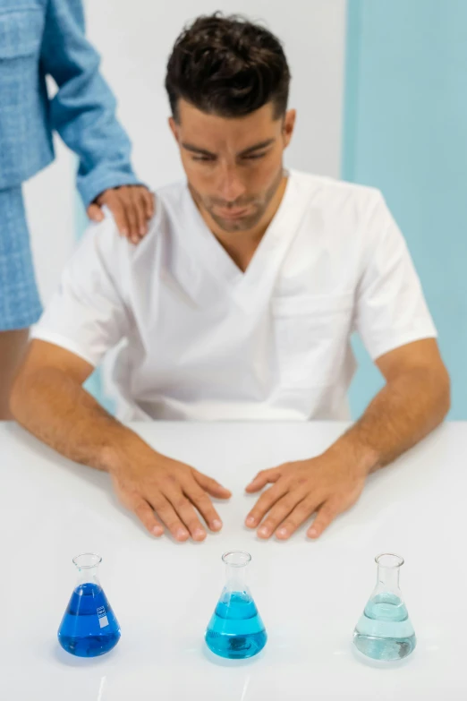 a man working on three conical glass items