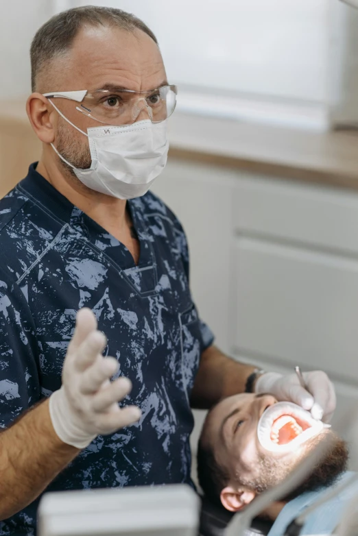 a man wearing goggles while brushing his teeth