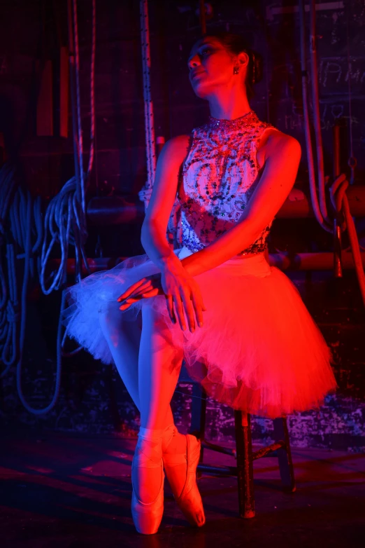 a woman in red sits on a chair