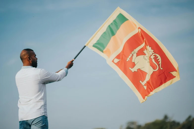 a man holding a flag outside in the sun