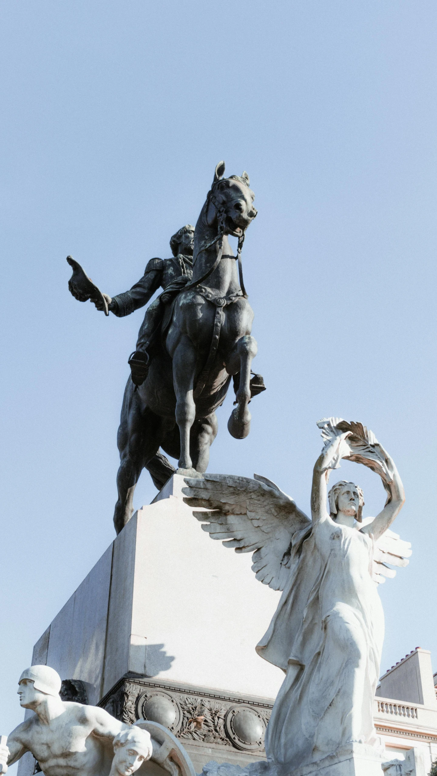 the statue of a man on a horse is in front of a building