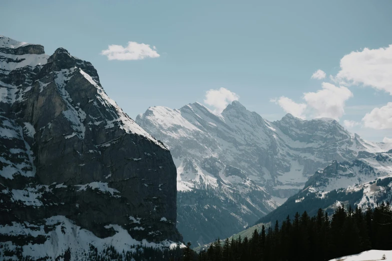 the snowy mountains are covered with thick white clouds