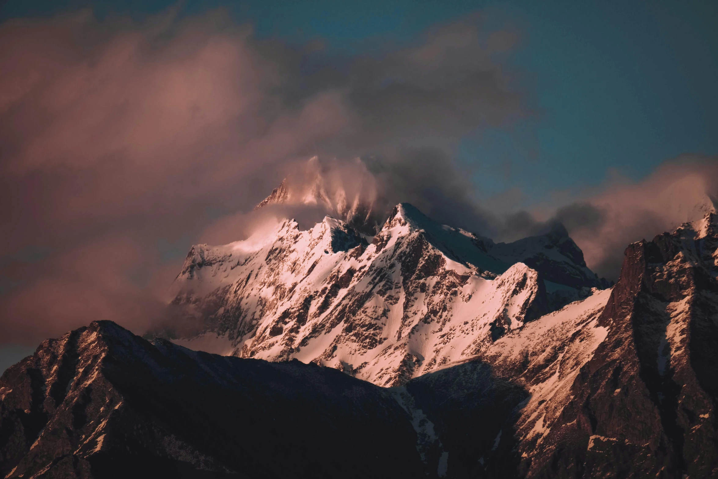 the top of the mountains looks like clouds roll over it