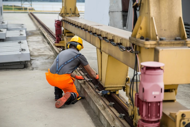 a worker standing on a conveyor belt looking for the train