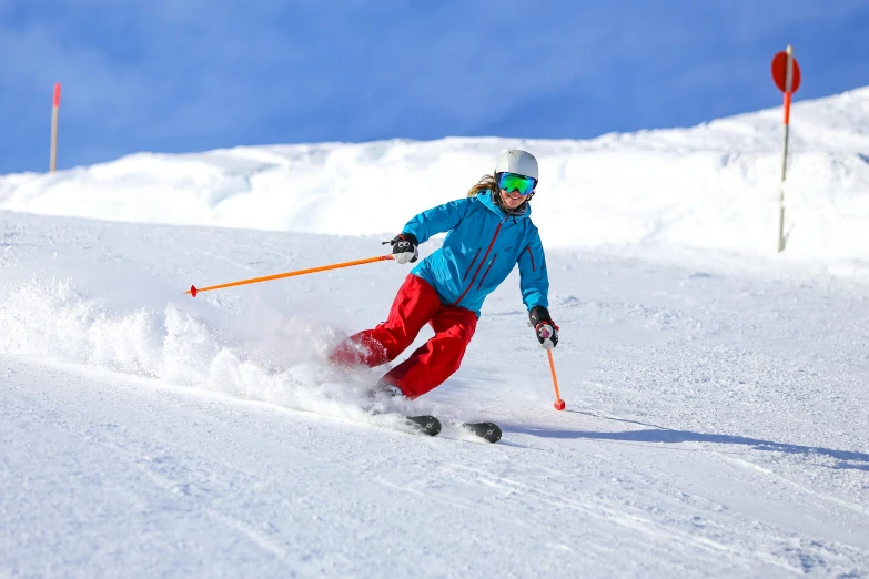 a woman on skis going down a snowy slope