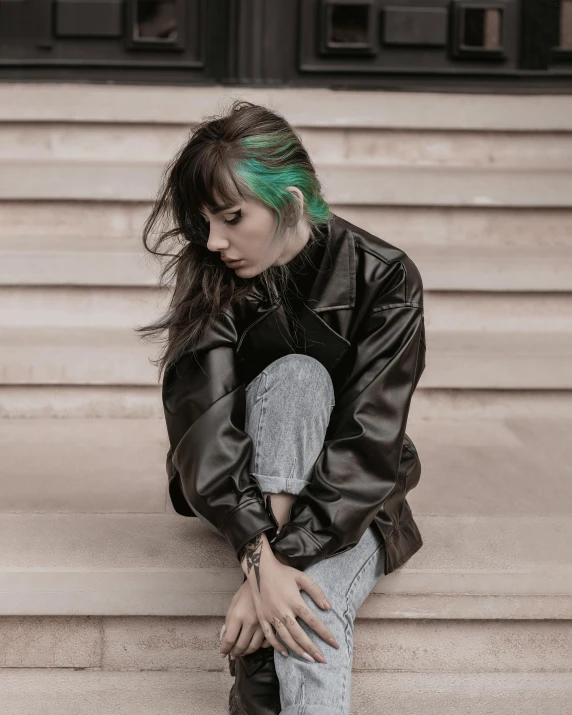 woman with green hair sitting down on steps