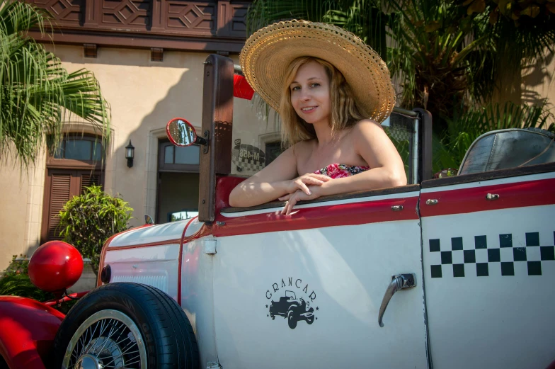 a women sitting on the back of an old truck