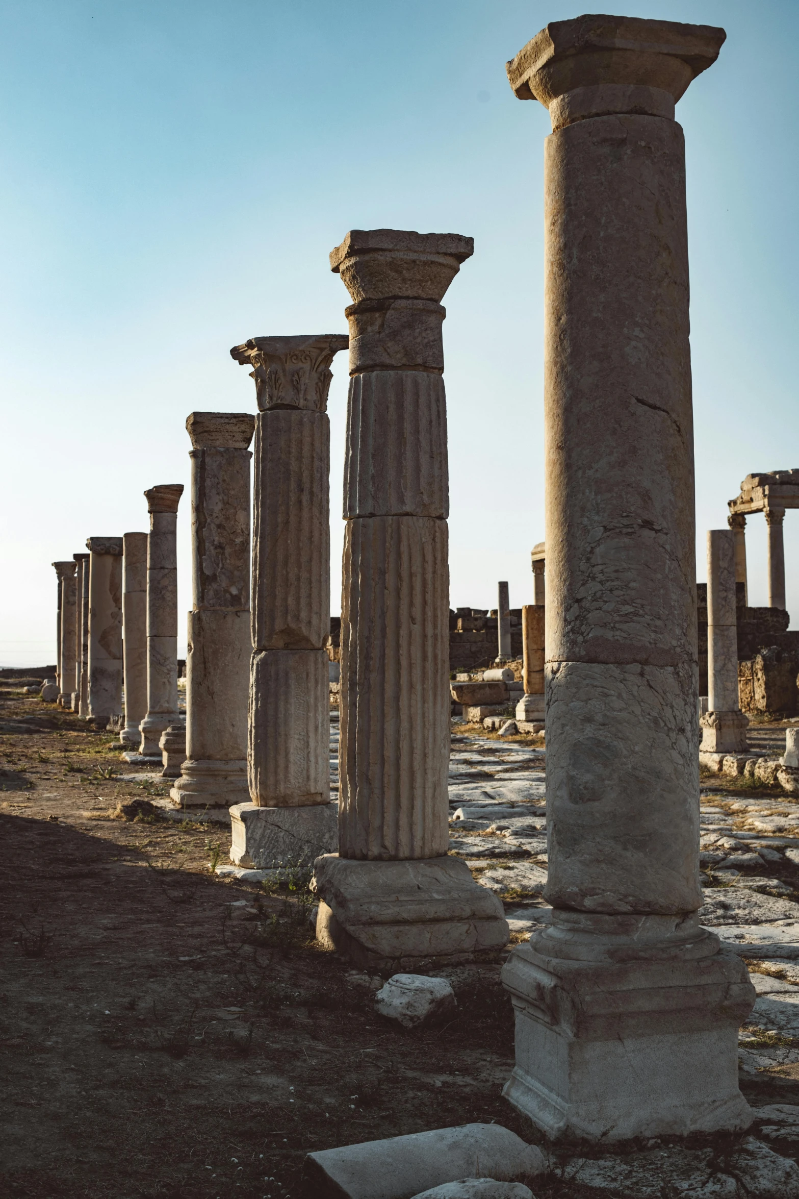 some very large old stone pillars in the dirt