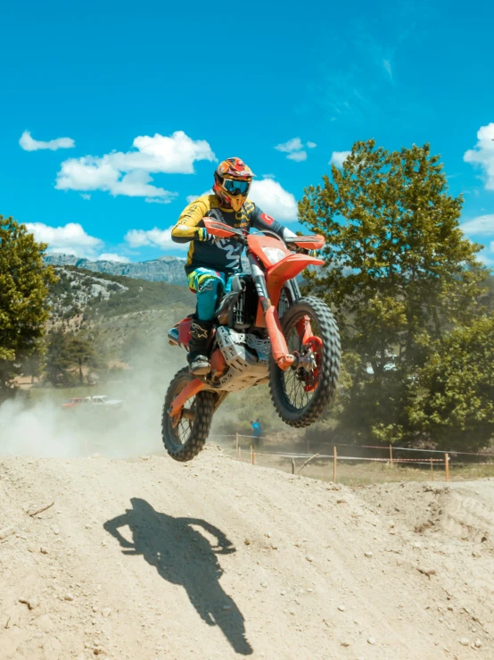 a dirt bike rider on a red bike in the air