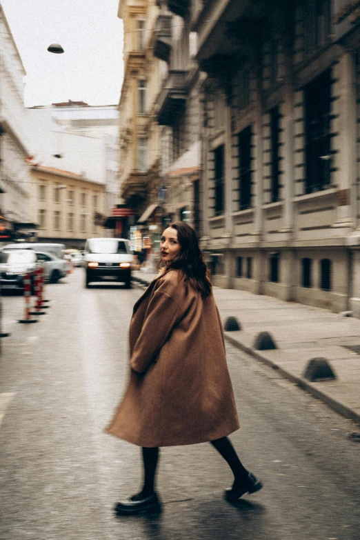 a woman is walking in the middle of the street