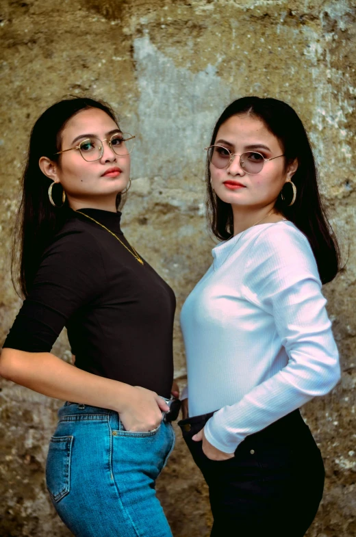 two women pose for the camera with their hands on their hips